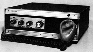 Radio transceiver with 4 knobs on front and microphone hung? on right front